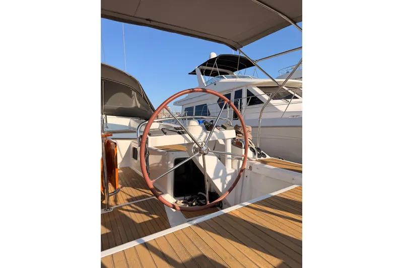 Motu Yacht Photos Pics 2013 Jeanneau 57 yacht helm with wooden deck and steering wheel.