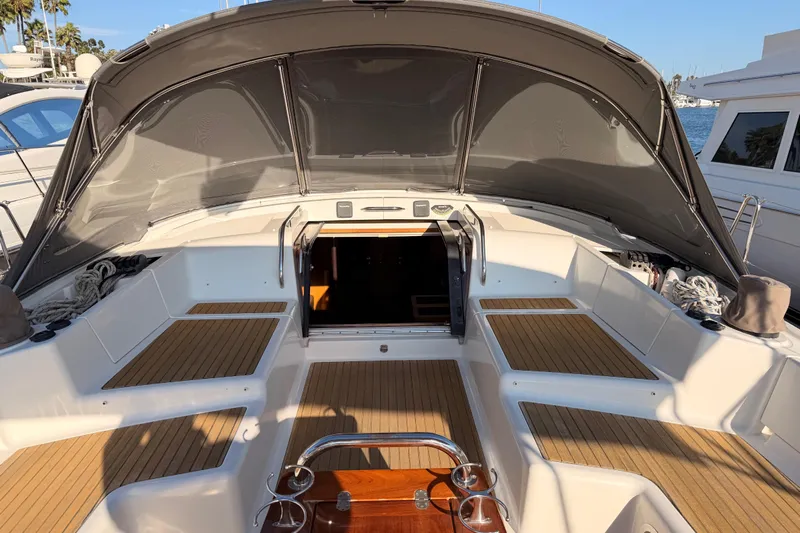 Motu Yacht Photos Pics 2013 Jeanneau 57 yacht cockpit with teak flooring and sunshade canopy.