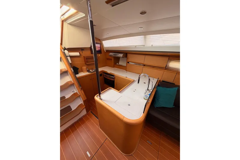 Motu Yacht Photos Pics Luxurious interior of 2013 Jeanneau 57 yacht with modern kitchen and seating area.