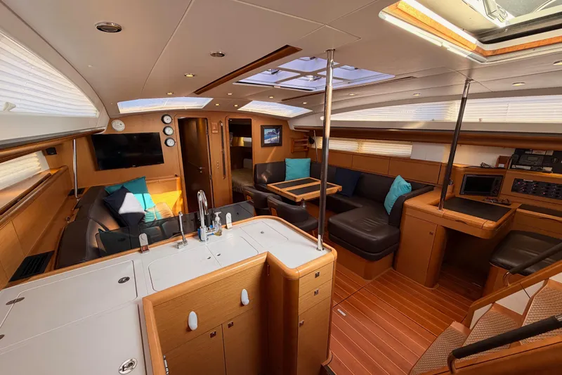Motu Yacht Photos Pics Luxurious interior of a 2013 Jeanneau 57 yacht with modern amenities and elegant design.