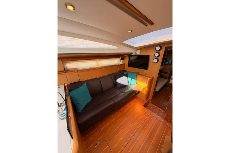 Motu Yacht Photos Pics Luxurious interior of 2013 Jeanneau 57 yacht with leather seating and modern decor.