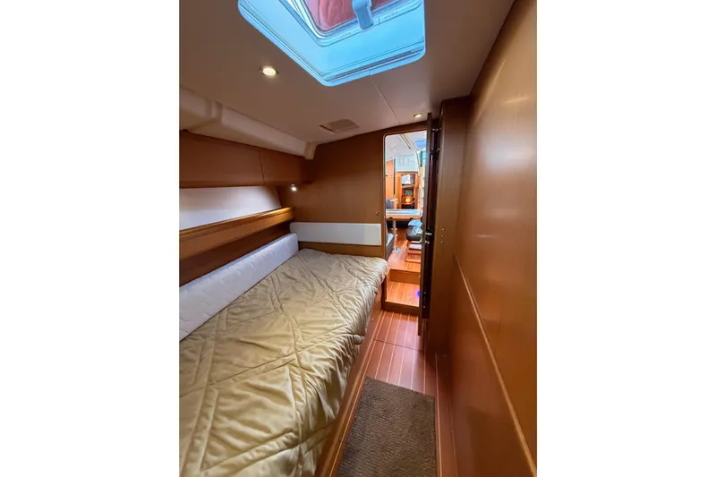 Motu Yacht Photos Pics 2013 Jeanneau 57 yacht interior cabin with bed and skylight.