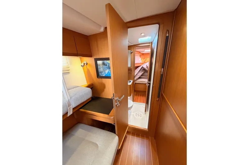 Motu Yacht Photos Pics 2013 Jeanneau 57 yacht interior with cozy cabin and wooden finishes.