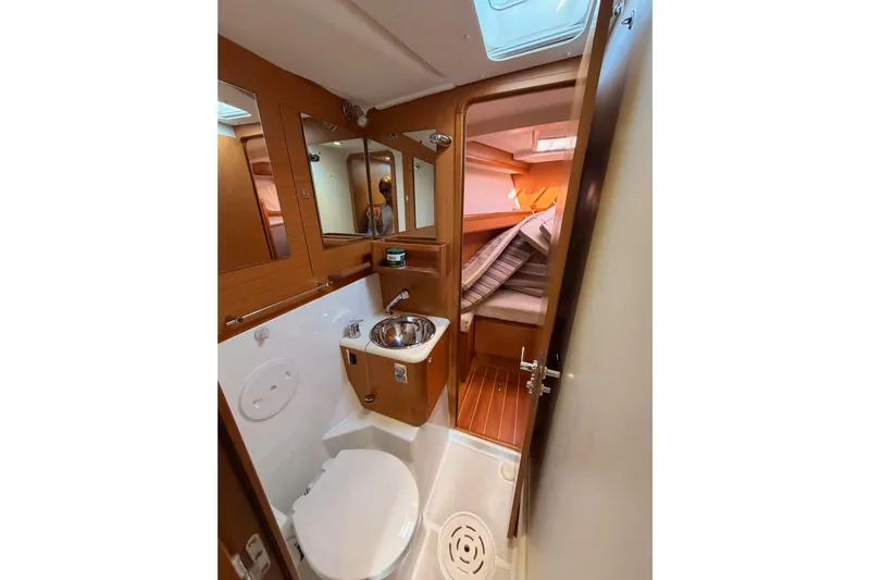 Motu Yacht Photos Pics 2013 Jeanneau 57 yacht bathroom with wooden accents and compact design.