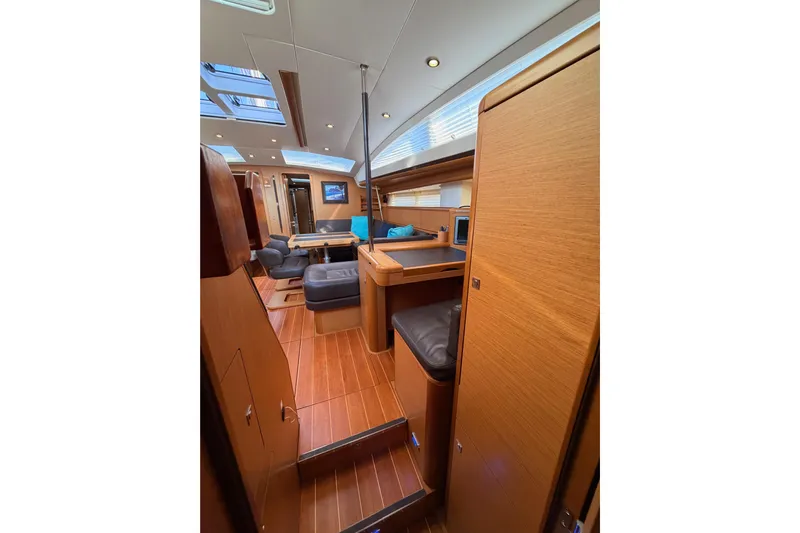 Motu Yacht Photos Pics Luxurious interior of 2013 Jeanneau 57 yacht with wood finish and modern seating.