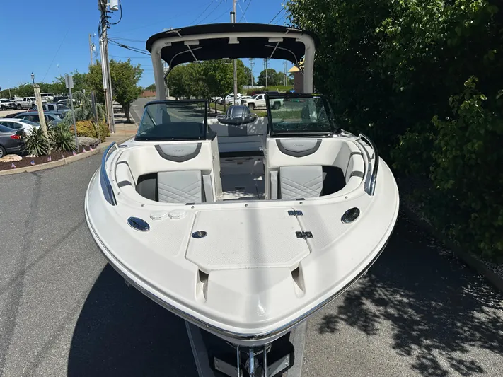  Yacht Photos Pics 2023 Chaparral 270 OSX boat, sleek design, parked outdoors on a sunny day.