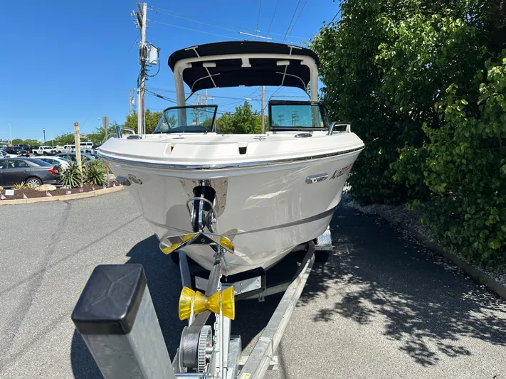  Yacht Photos Pics 2023 Chaparral 270 OSX boat on trailer, parked outdoors, sunny day.