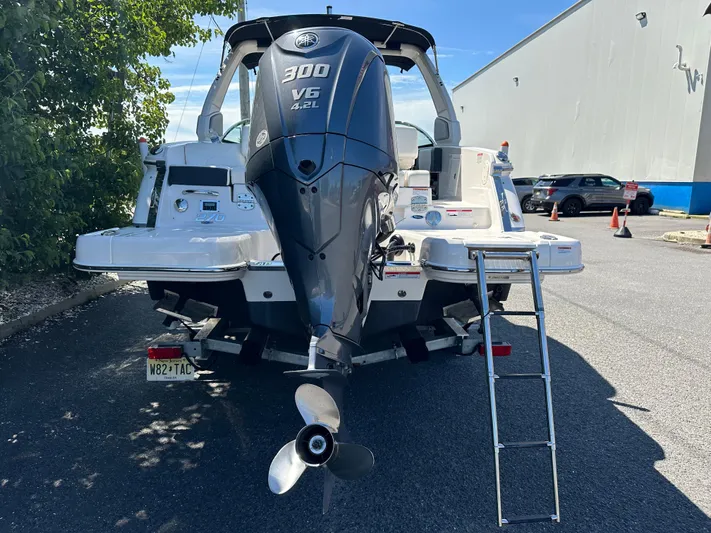  Yacht Photos Pics 2023 Chaparral 270 OSX boat with Yamaha 300 V6 engine, parked outdoors.