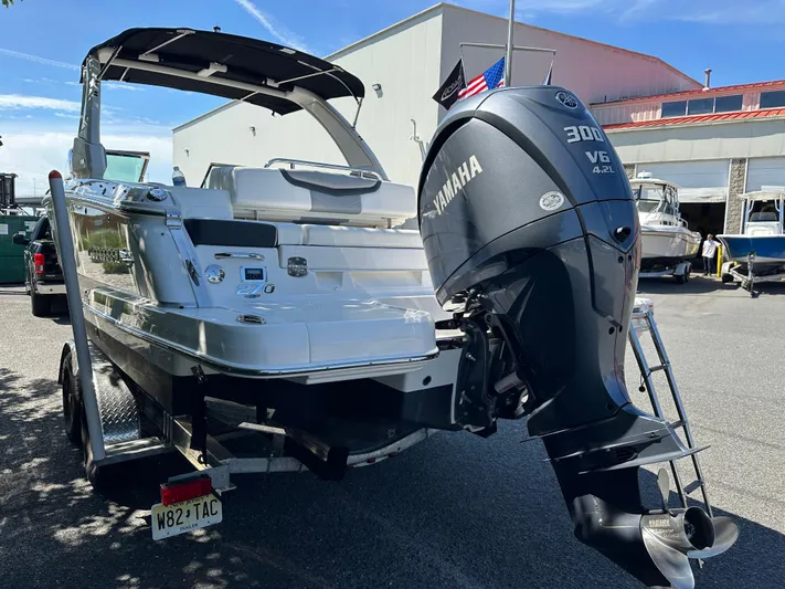  Yacht Photos Pics 2023 Chaparral 270 OSX boat with Yamaha 300 V6 engine, parked outdoors.