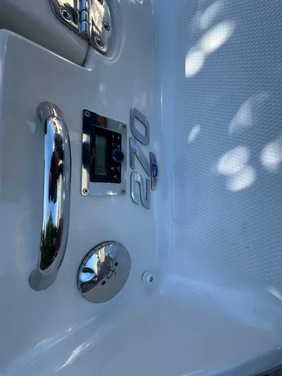  Yacht Photos Pics 2023 Chaparral 270 OSX boat detail with chrome accents and control panel.
