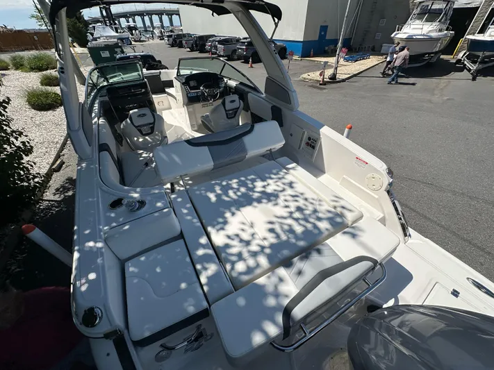  Yacht Photos Pics 2023 Chaparral 270 OSX boat with spacious seating and modern design in a marina setting.