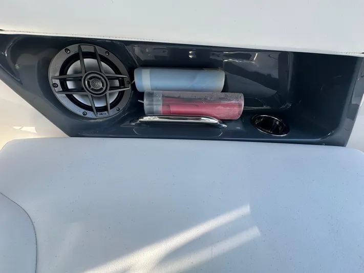  Yacht Photos Pics 2023 Chaparral 270 OSX boat interior with speaker and storage compartment.