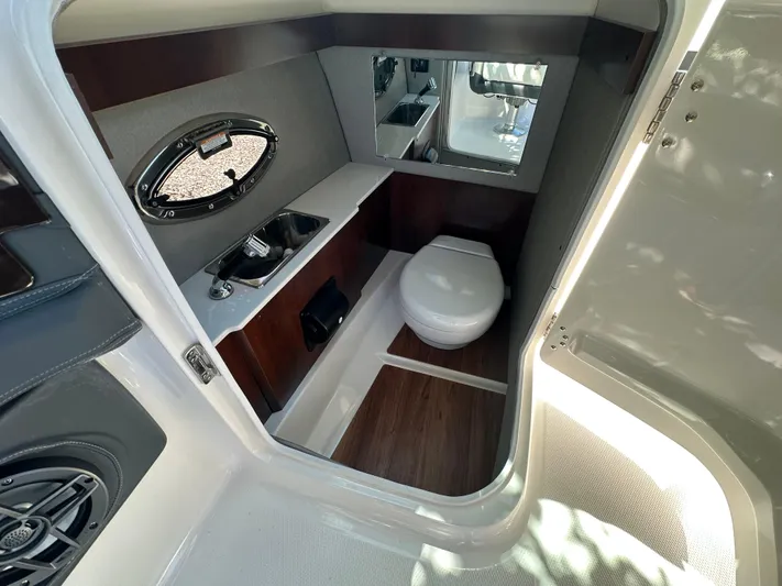  Yacht Photos Pics 2023 Chaparral 270 OSX boat interior with sink and toilet, featuring modern design.