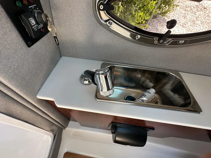  Yacht Photos Pics Interior sink area of 2023 Chaparral 270 OSX boat with window view.