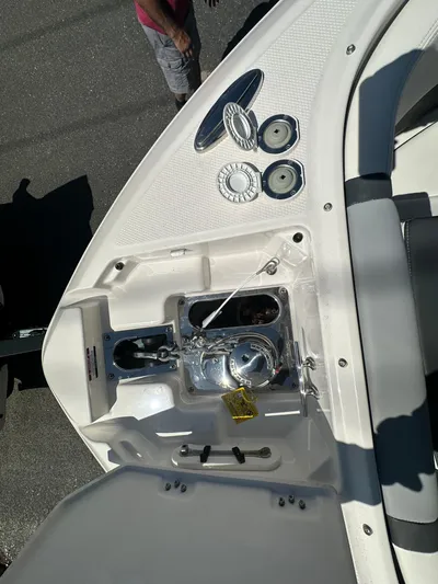  Yacht Photos Pics 2023 Chaparral 270 OSX boat deck with open storage compartment and visible hardware.