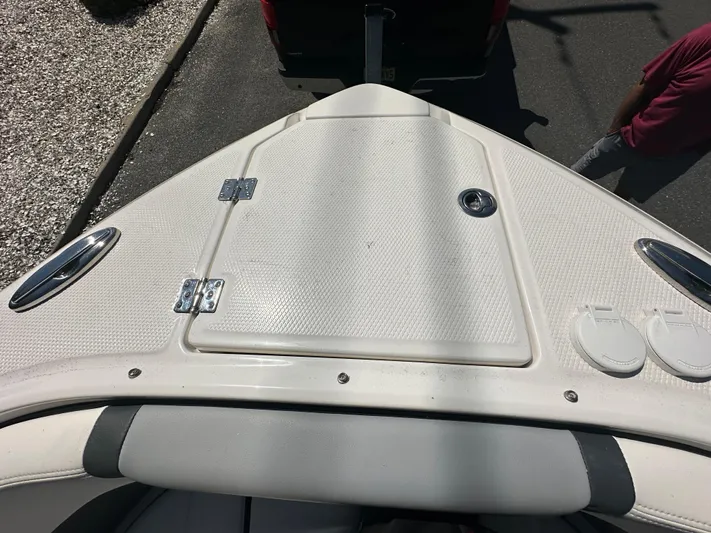  Yacht Photos Pics 2023 Chaparral 270 OSX boat bow with storage hatch and sleek design.