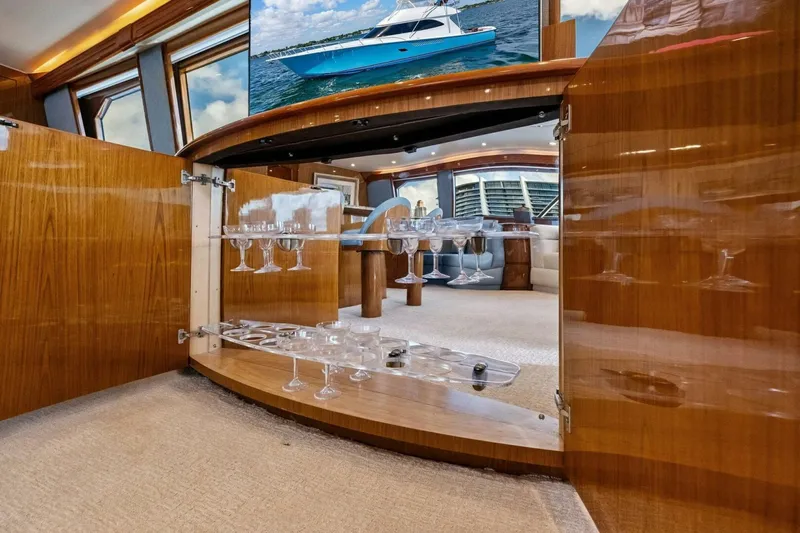 Lady Di Yacht Photos Pics Luxurious interior of 2012 Viking 82 Convertible yacht with elegant glassware display.