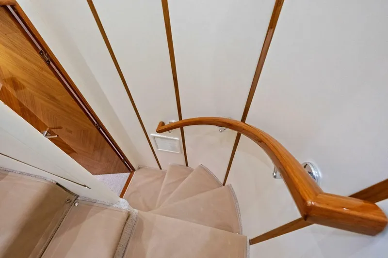 Lady Di Yacht Photos Pics Staircase with wooden handrail inside 2012 Viking 82 Convertible yacht.