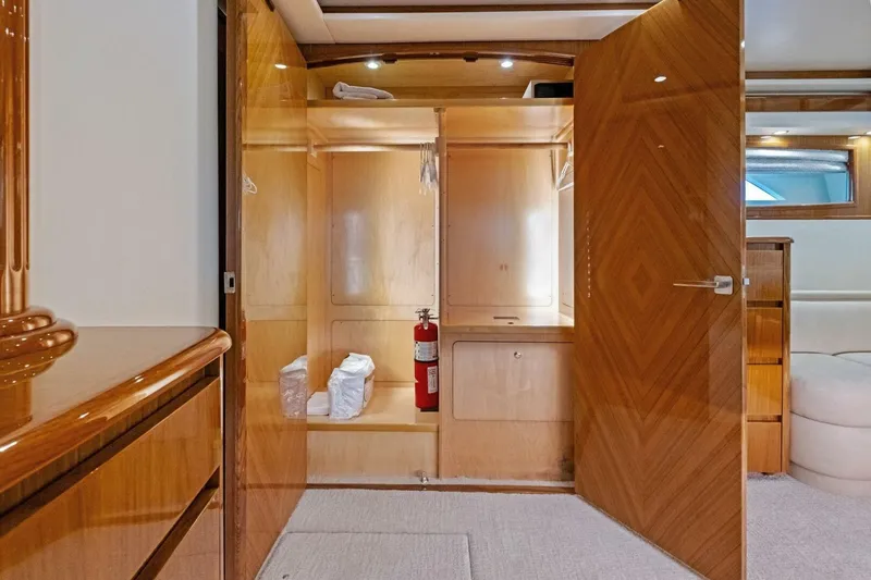 Lady Di Yacht Photos Pics Luxurious wooden interior of 2012 Viking 82 Convertible yacht with open closet and fire extinguisher.