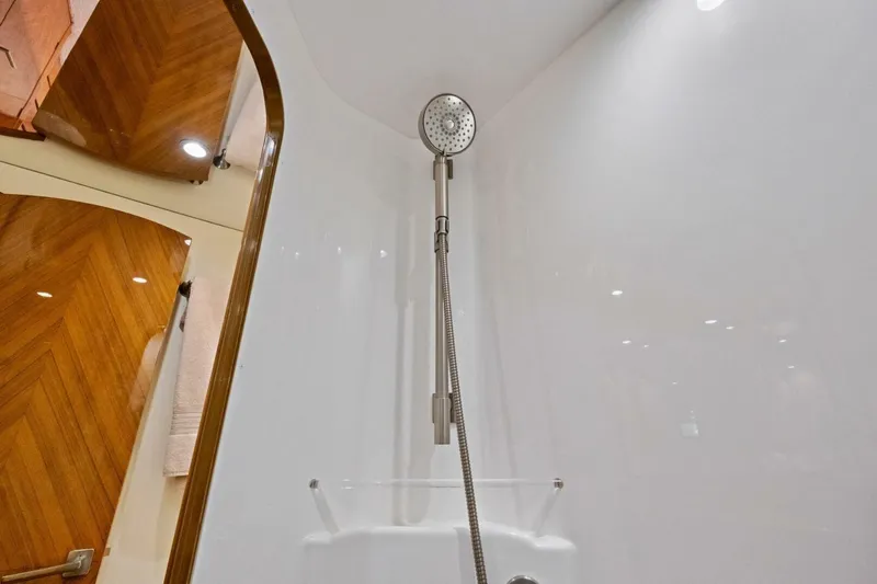 Lady Di Yacht Photos Pics Shower area in 2012 Viking 82 Convertible yacht with sleek wooden accents.