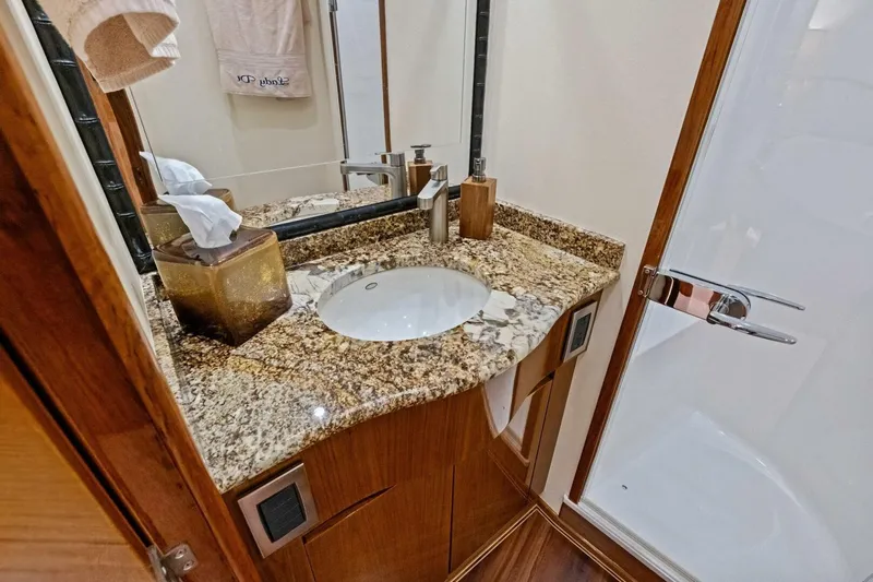 Lady Di Yacht Photos Pics Luxurious bathroom in 2012 Viking 82 Convertible yacht with granite countertop and modern fixtures.