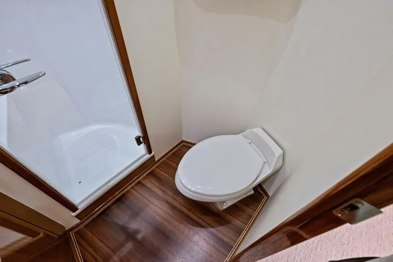 Lady Di Yacht Photos Pics Luxurious bathroom in 2012 Viking 82 Convertible yacht with wooden flooring.