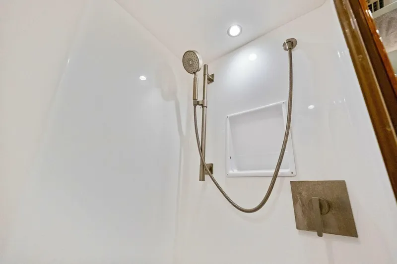 Lady Di Yacht Photos Pics Modern shower in 2012 Viking 82 Convertible yacht, featuring sleek fixtures and white interior.