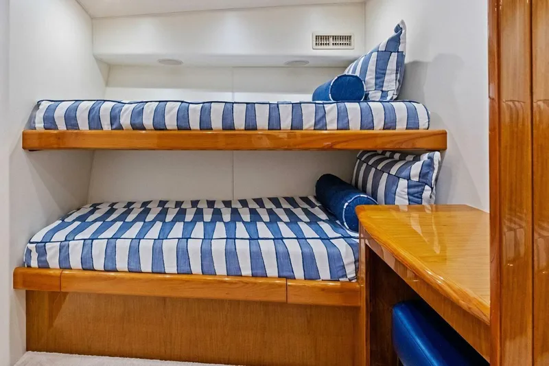 Lady Di Yacht Photos Pics Bunk beds with blue striped bedding in 2012 Viking 82 Convertible yacht cabin.