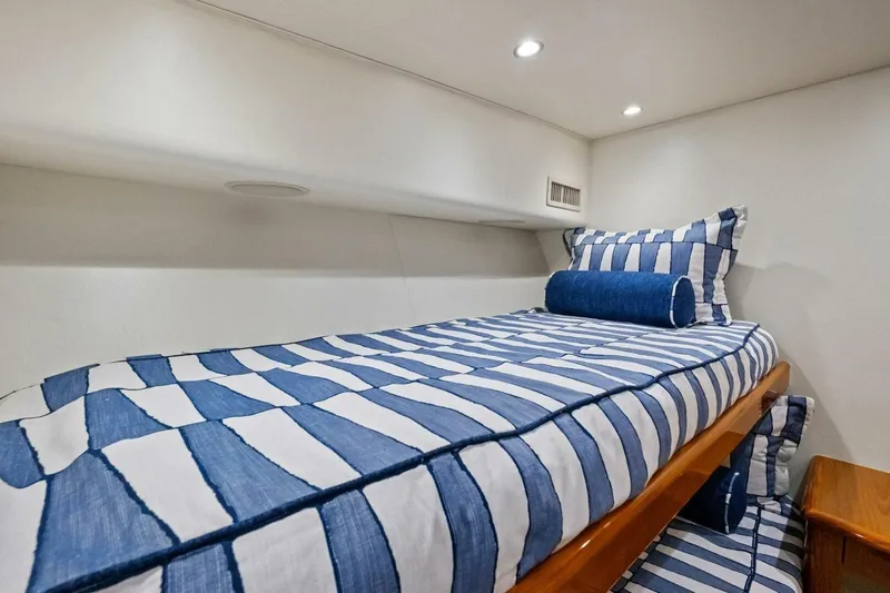 Lady Di Yacht Photos Pics Cozy cabin interior of 2012 Viking 82 Convertible yacht with striped bedding.