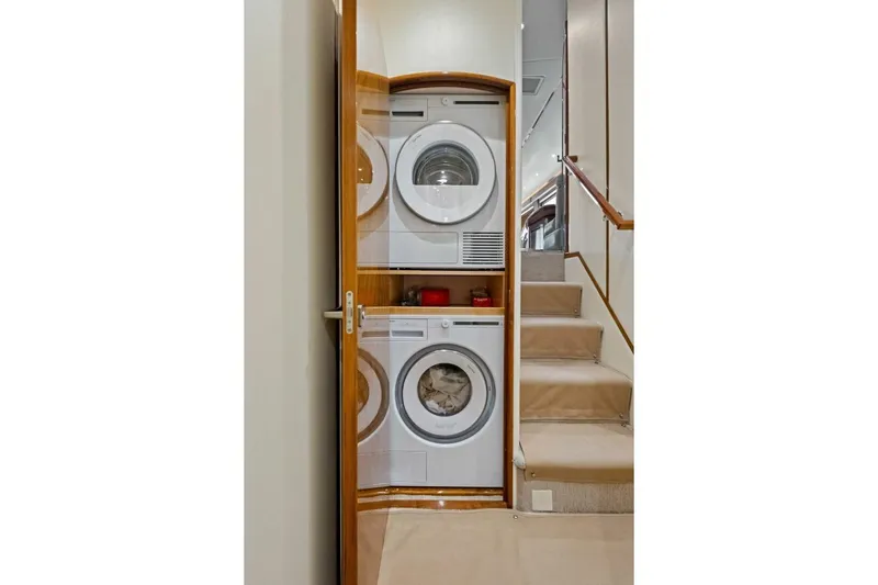 Lady Di Yacht Photos Pics Laundry area with stacked washer and dryer on 2012 Viking 82 Convertible yacht.