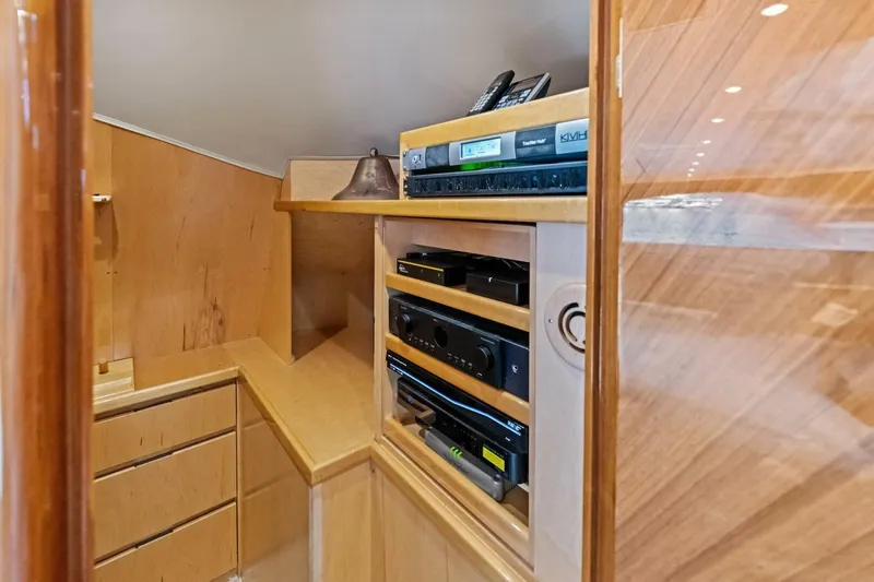 Lady Di Yacht Photos Pics Interior of 2012 Viking 82 Convertible yacht with wooden cabinetry and electronic equipment.