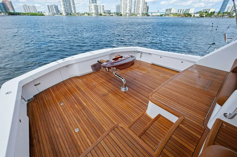 Lady Di Yacht Photos Pics Luxurious 2012 Viking 82 Convertible yacht deck with wooden flooring and scenic waterfront view.