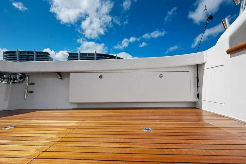 Lady Di Yacht Photos Pics 2012 Viking 82 Convertible yacht deck with wooden flooring and clear blue sky.