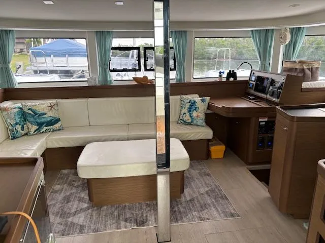 Gone Again Yacht Photos Pics Luxurious interior of 2019 Lagoon 42 catamaran with modern seating and nautical decor.