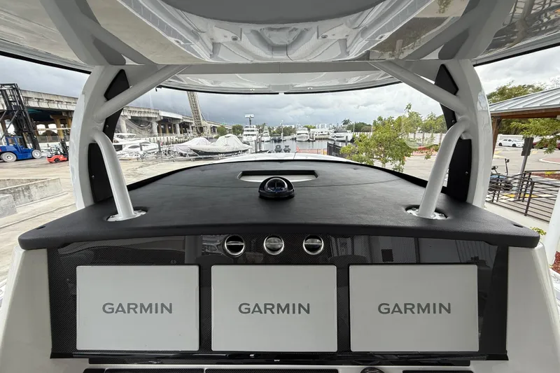  Yacht Photos Pics 2021 Fountain 43 NX boat dashboard with Garmin navigation systems at a marina.