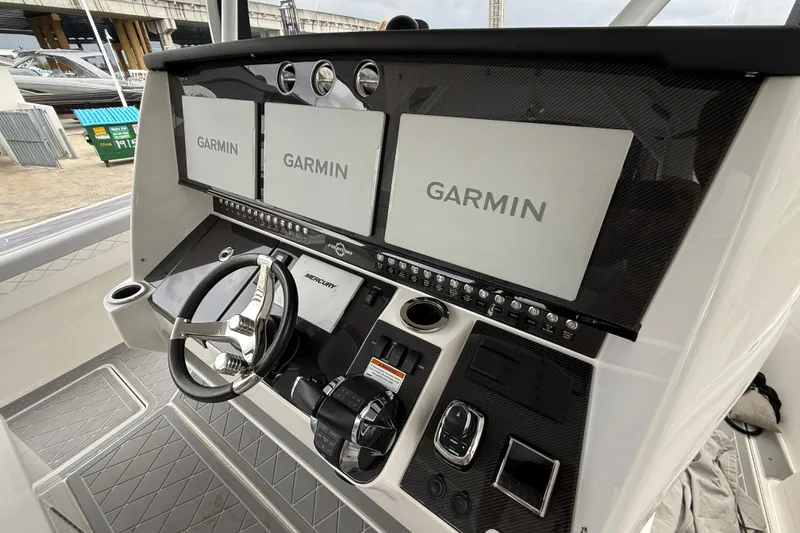  Yacht Photos Pics 2021 Fountain 43 NX boat dashboard with Garmin displays and Mercury controls.