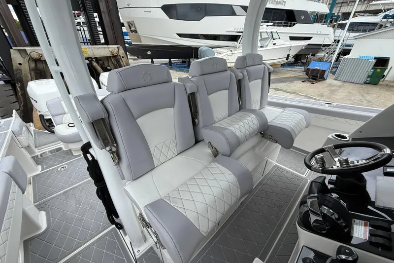  Yacht Photos Pics 2021 Fountain 43 NX boat interior with luxurious seating and modern steering console.