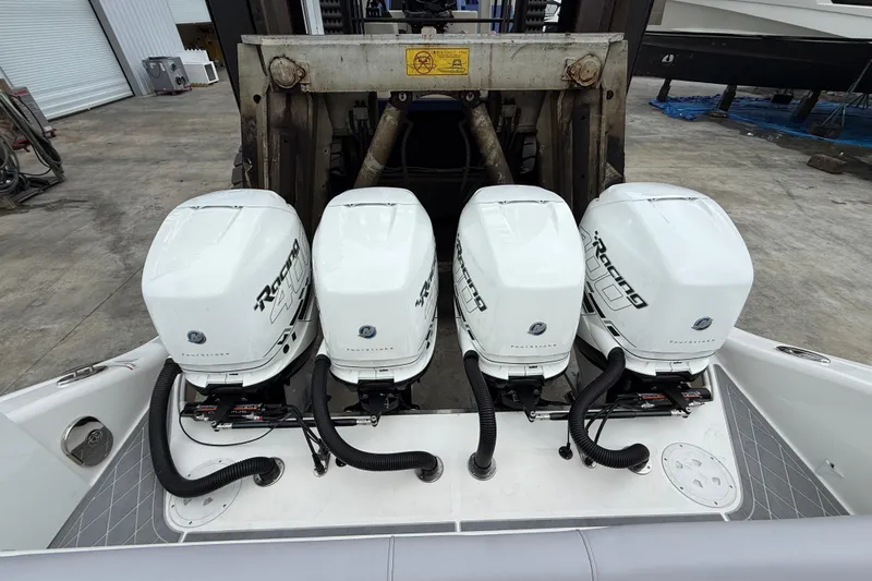  Yacht Photos Pics Four powerful outboard engines on a 2021 Fountain 43 NX boat, docked in a marina.
