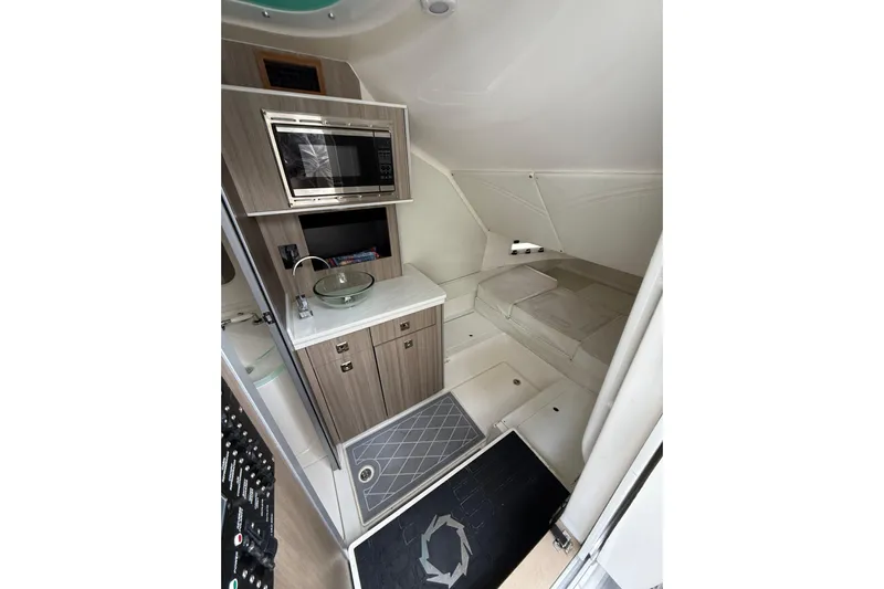  Yacht Photos Pics Interior of 2021 Fountain 43 NX boat with kitchenette and sleeping area.