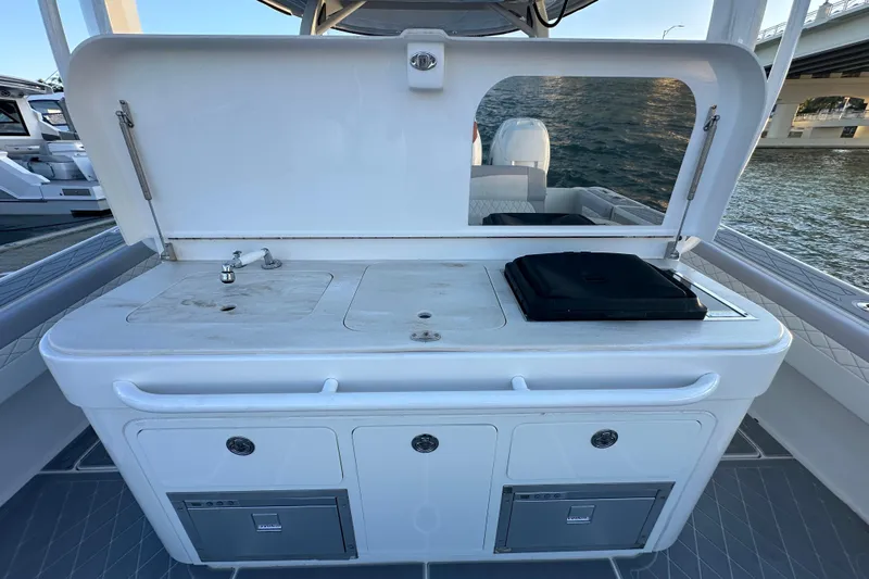  Yacht Photos Pics Outdoor kitchen on 2021 Fountain 43 NX boat with sink and grill.