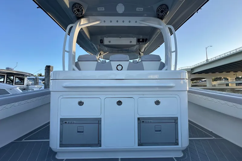  Yacht Photos Pics 2021 Fountain 43 NX boat interior with storage compartments and seating under a clear sky.
