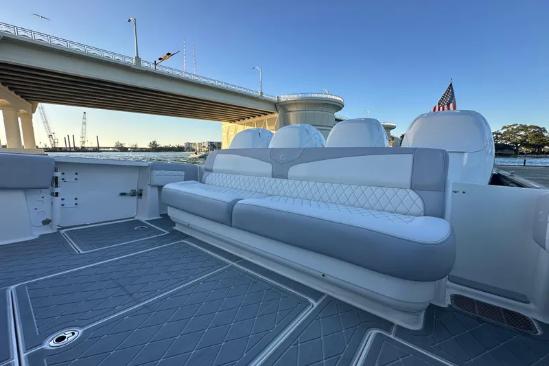  Yacht Photos Pics 2021 Fountain 43 NX boat interior with cushioned seating under a bridge.