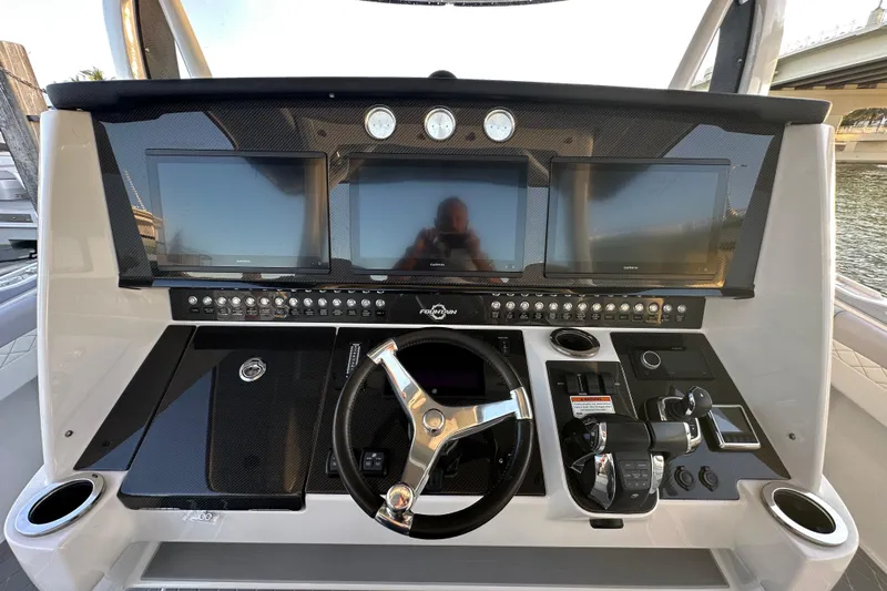  Yacht Photos Pics 2021 Fountain 43 NX boat dashboard with multiple screens and controls.