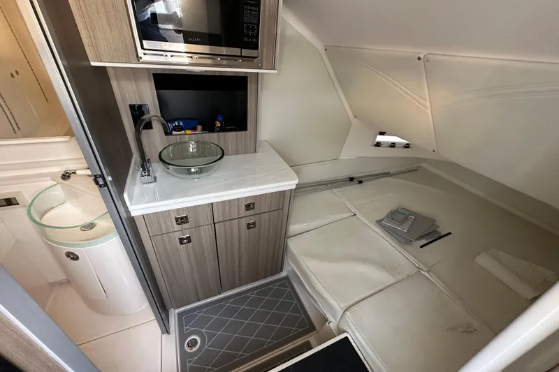  Yacht Photos Pics Interior of 2021 Fountain 43 NX boat with kitchenette and seating area.