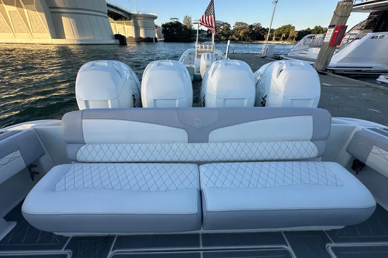  Yacht Photos Pics 2021 Fountain 43 NX boat with luxurious seating and powerful engines docked by the water.