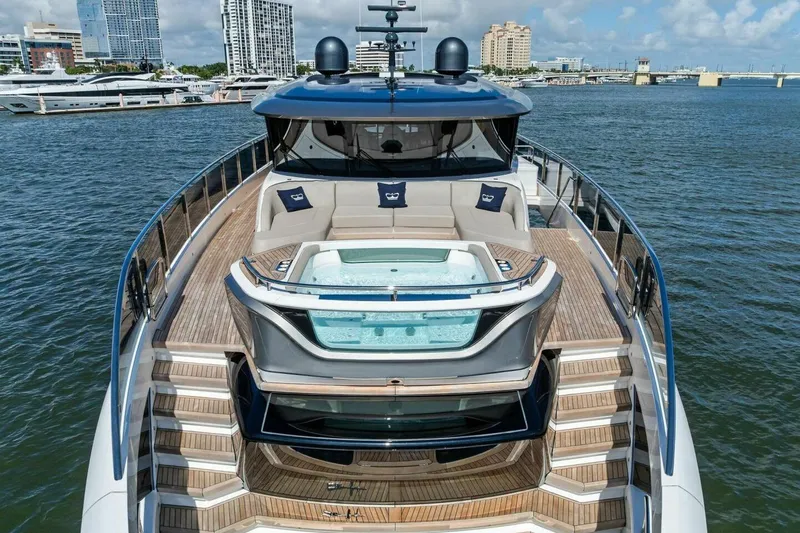 Lady Lion Yacht Photos Pics Luxurious 2023 Princess X95 yacht with jacuzzi, docked in a scenic marina.