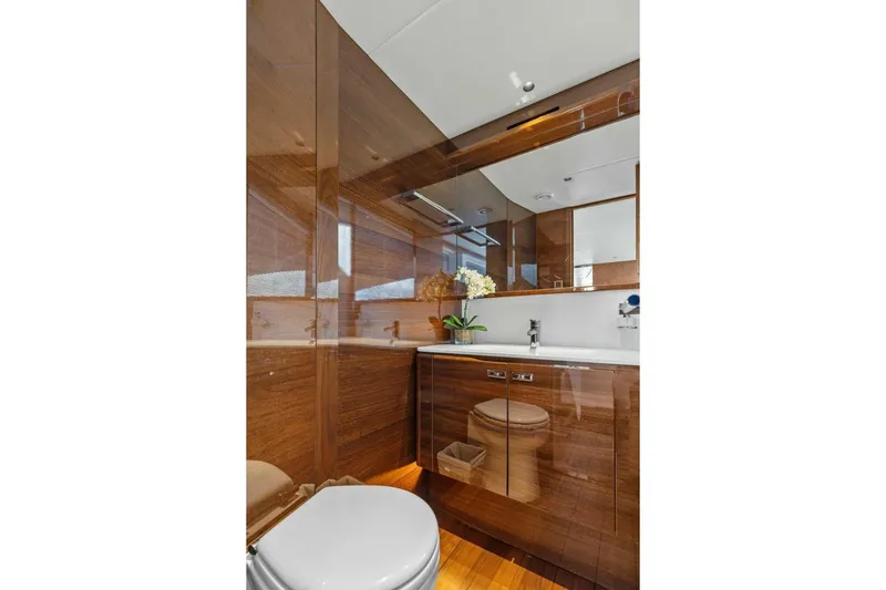 Lady Lion Yacht Photos Pics Luxurious bathroom interior on 2023 Princess X95 yacht, featuring wood finishes and modern fixtures.