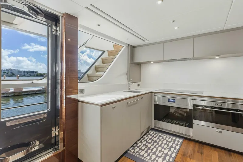 Lady Lion Yacht Photos Pics Luxurious kitchen interior of 2023 Princess X95 yacht with modern appliances and scenic water view.
