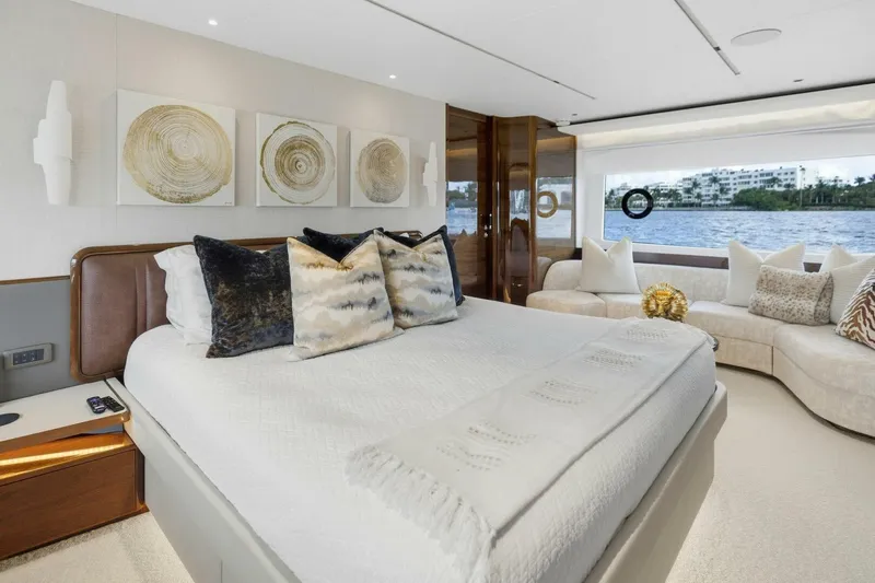 Lady Lion Yacht Photos Pics Luxurious 2023 Princess X95 yacht bedroom with elegant decor and waterfront view.