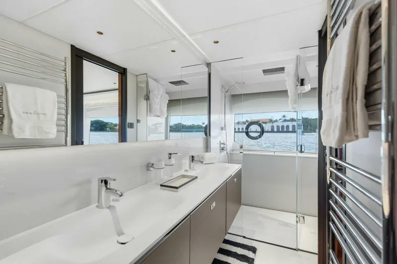Lady Lion Yacht Photos Pics Luxurious bathroom interior of 2023 Princess X95 yacht with dual sinks and scenic window view.